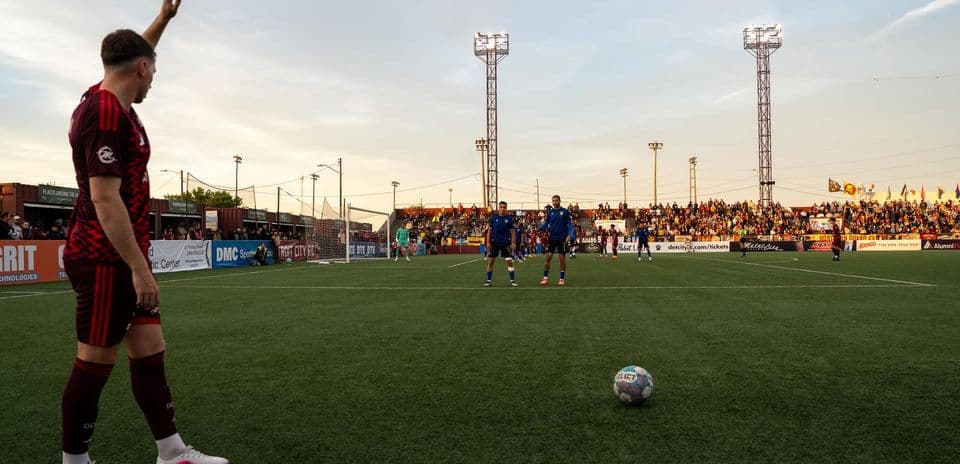 Player preparing for a free kick in match