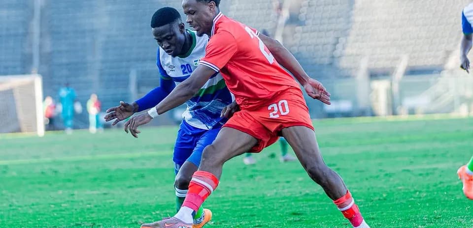 Two players battling for the ball on field