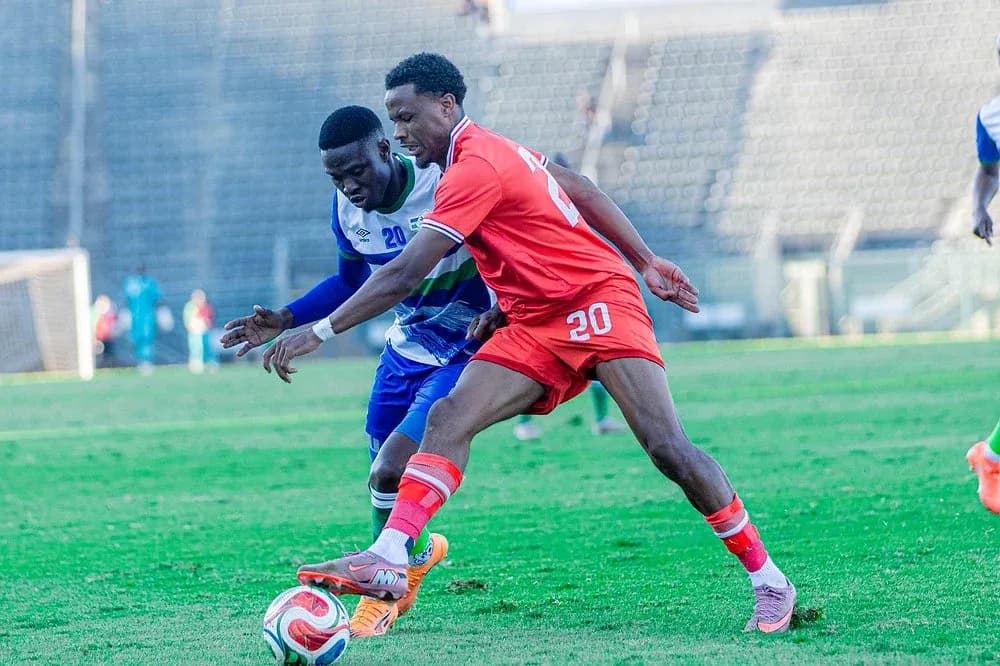 Two players battling for the ball on field