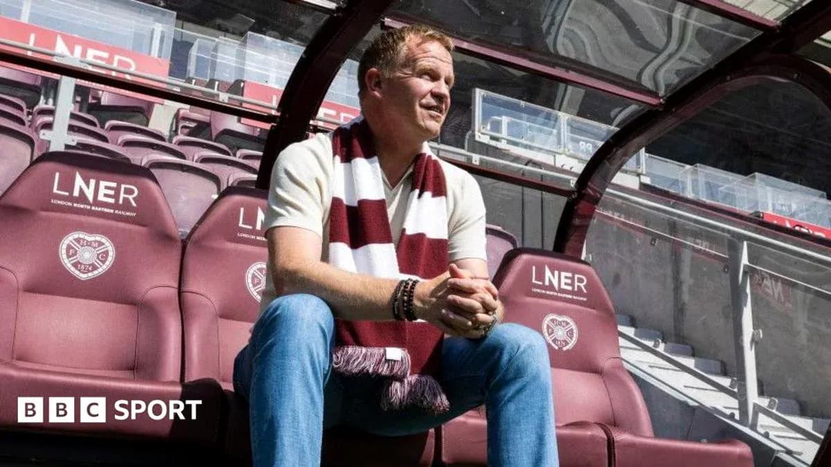 Manager seated in dugout at football stadium