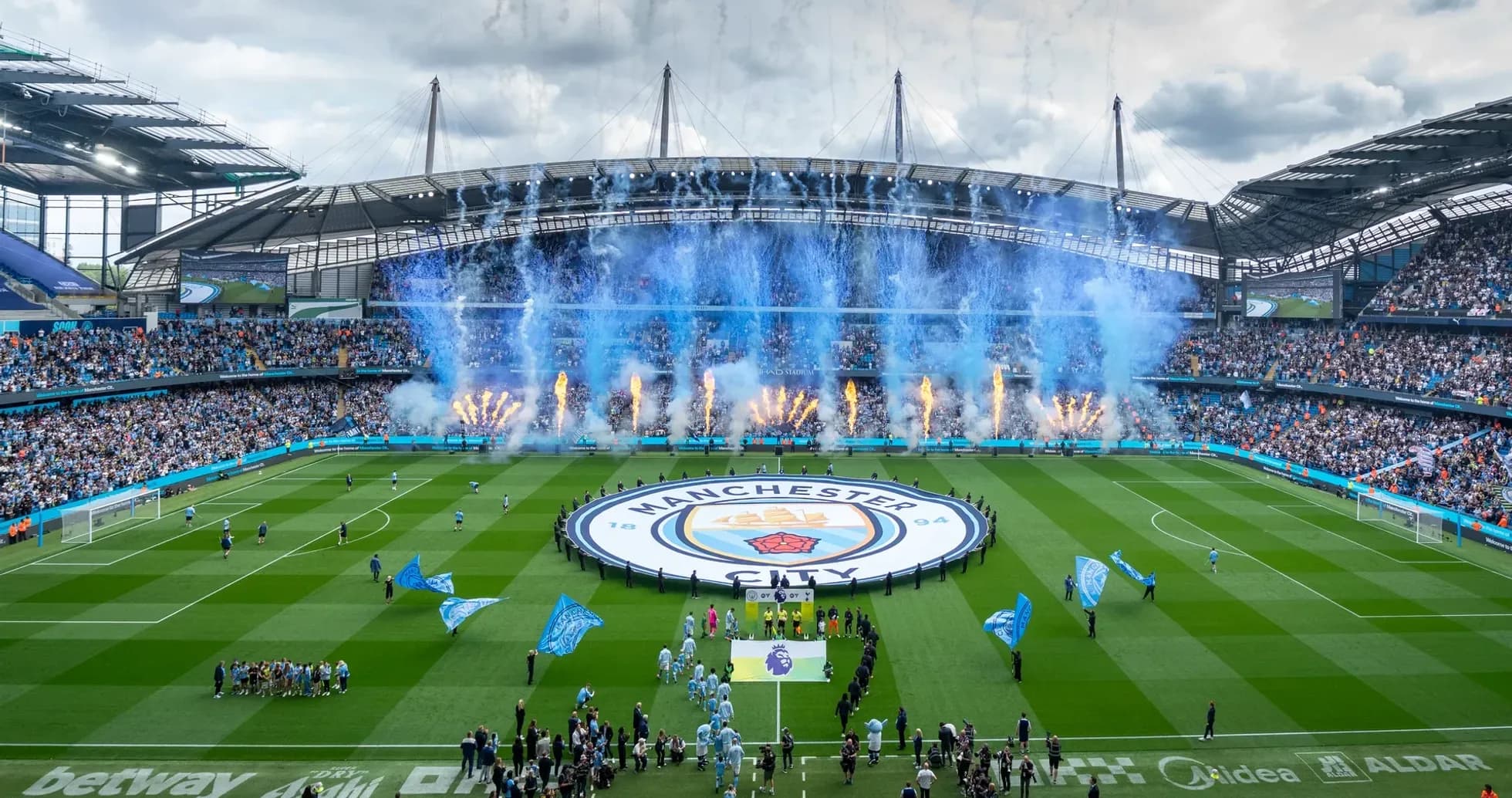 Manchester City stadium with fans and fireworks