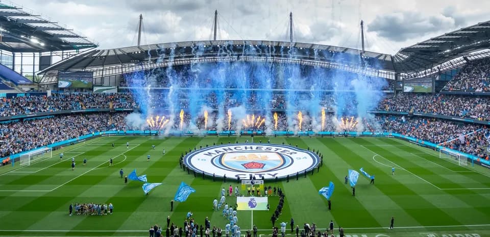 Manchester City stadium with fans and fireworks