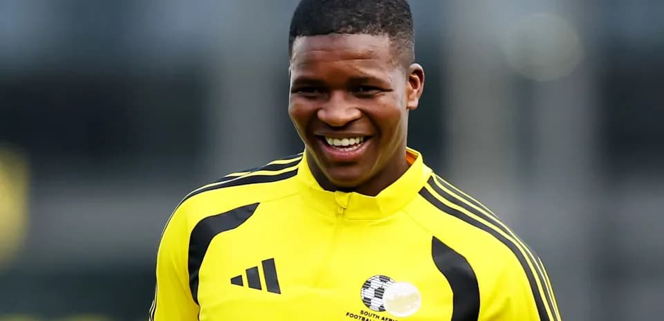 Player in yellow training kit smiling during practice