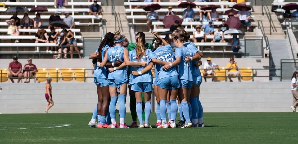 Team huddling together before the match