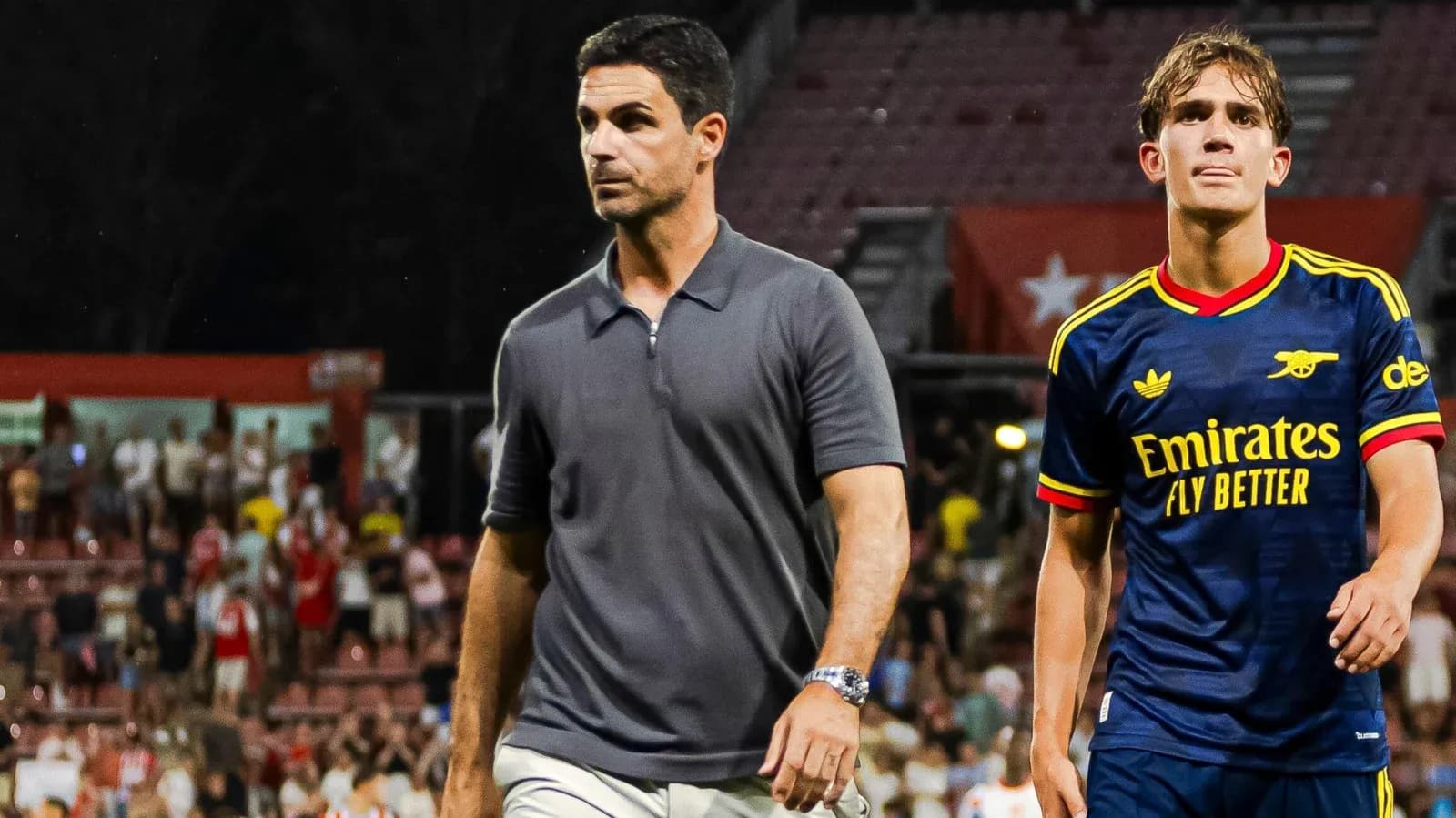 Manager and player walking off the pitch