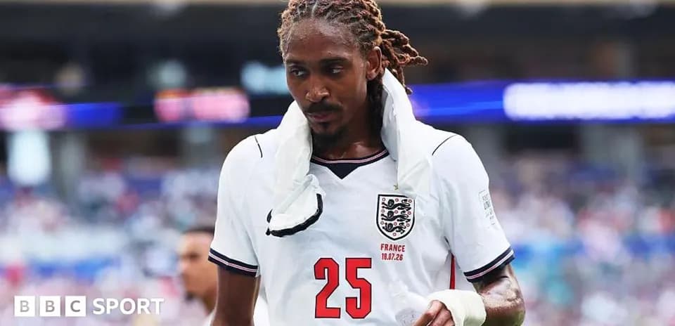 Player wearing England jersey walking on the pitch