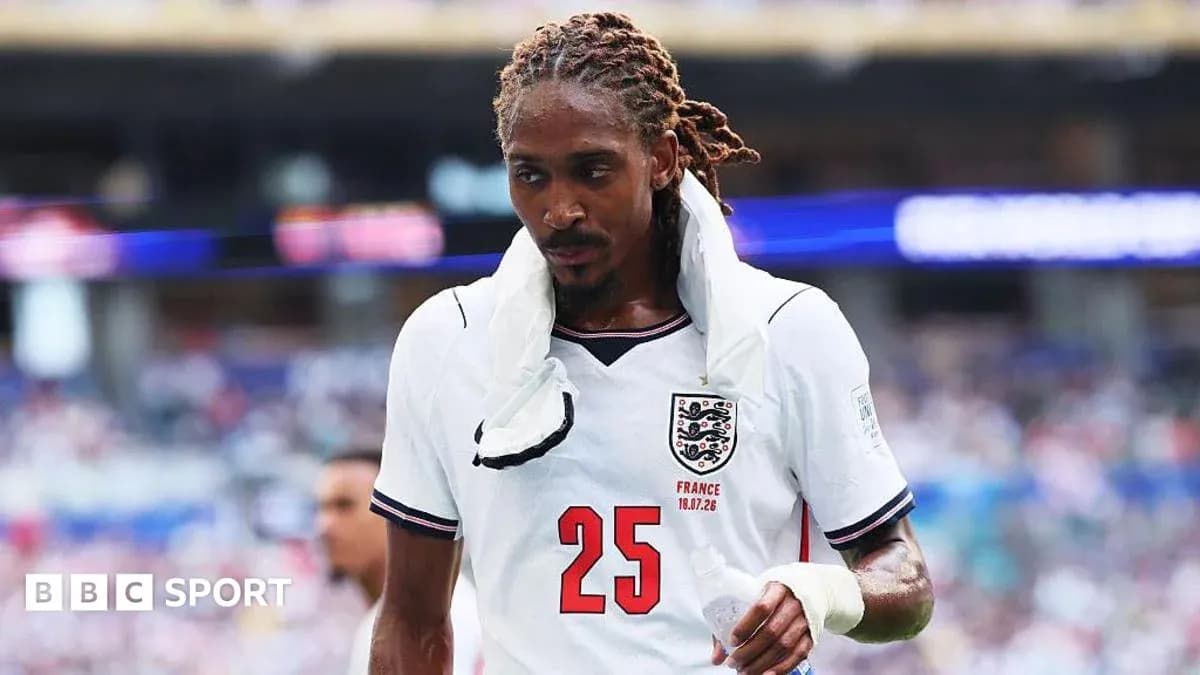 Player wearing England jersey walking on the pitch