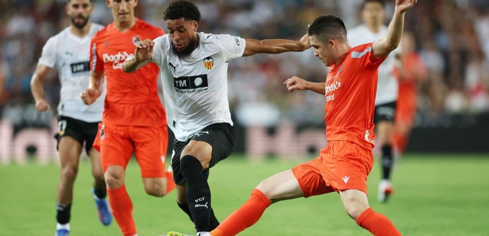 Real Sociedad and Valencia players battling for the ball