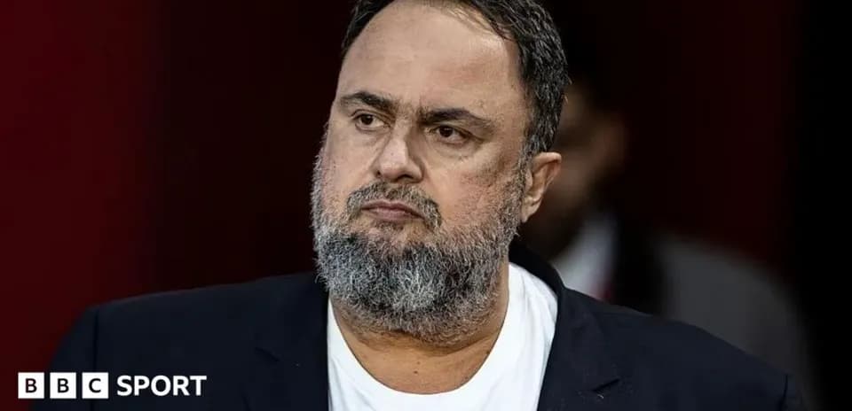Man with beard in suit looking thoughtfully