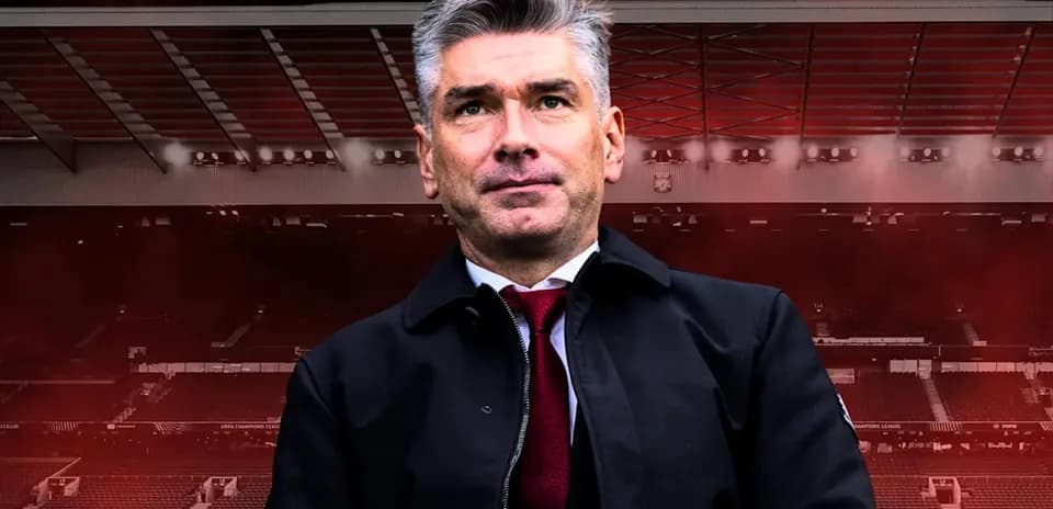 Manager standing in front of stadium backdrop