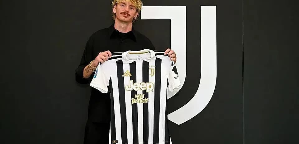 Player holding Juventus jersey during presentation event