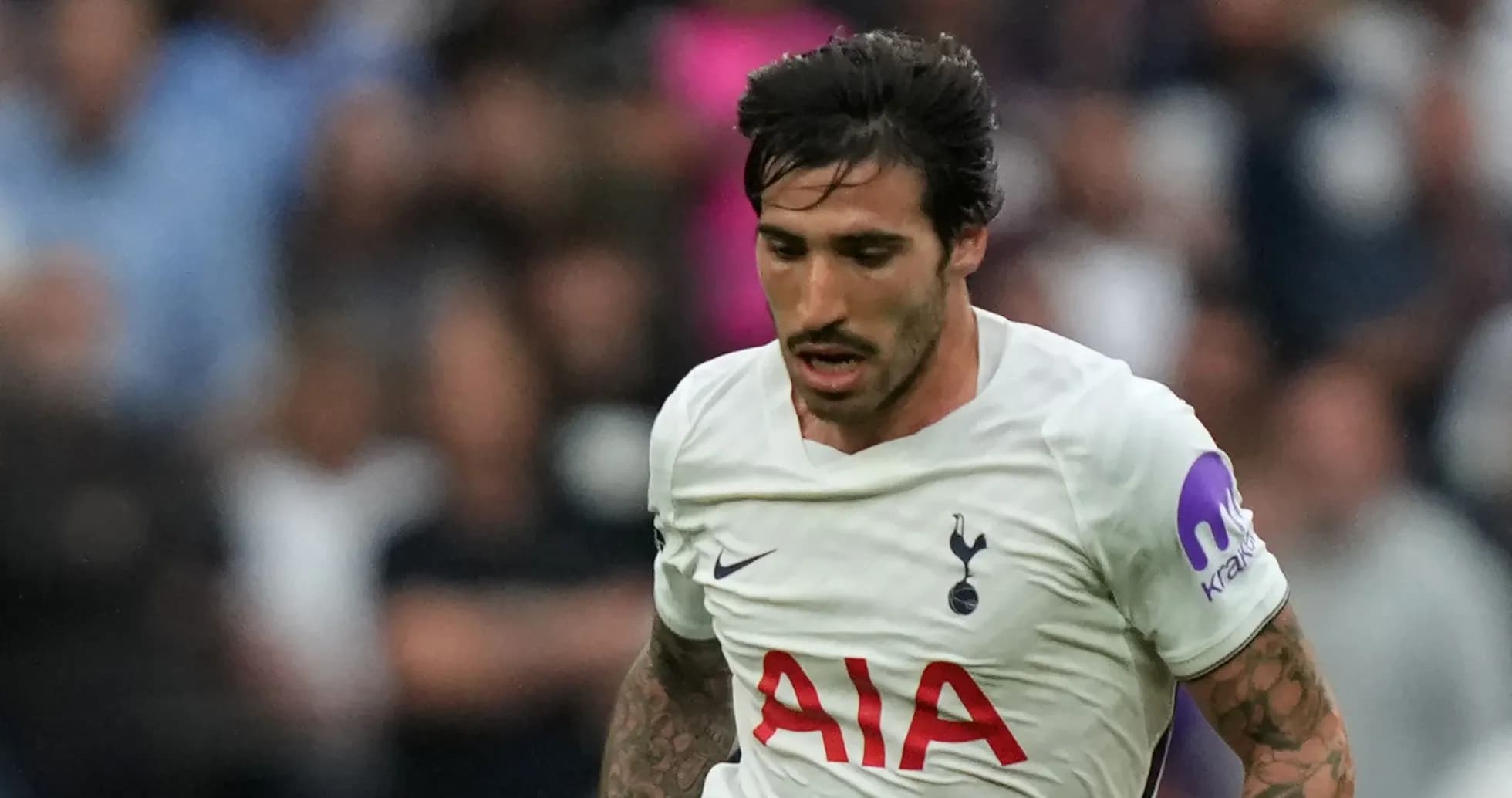 Player running during match wearing Tottenham jersey