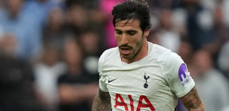 Player running during match wearing Tottenham jersey