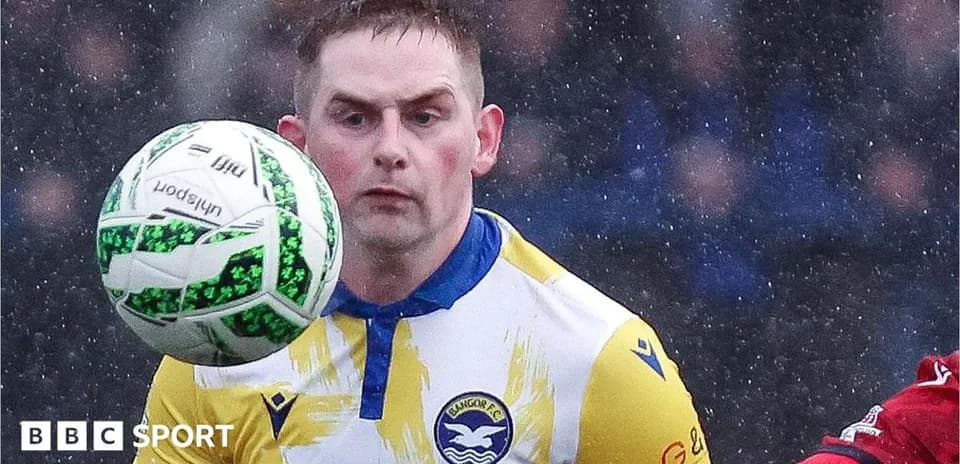 Player controlling ball during a rainy match