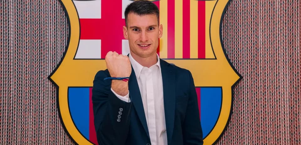 Player posing with fist raised at Barcelona logo