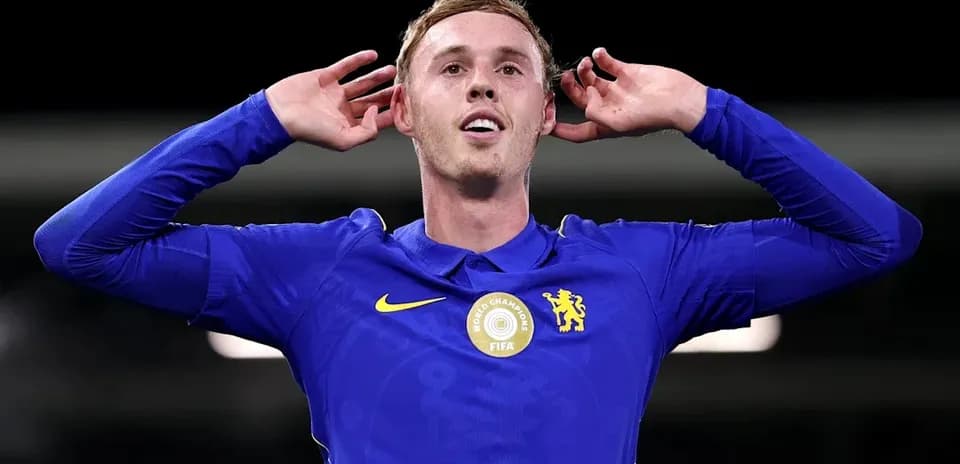 Player celebrating with hands behind ears in jersey