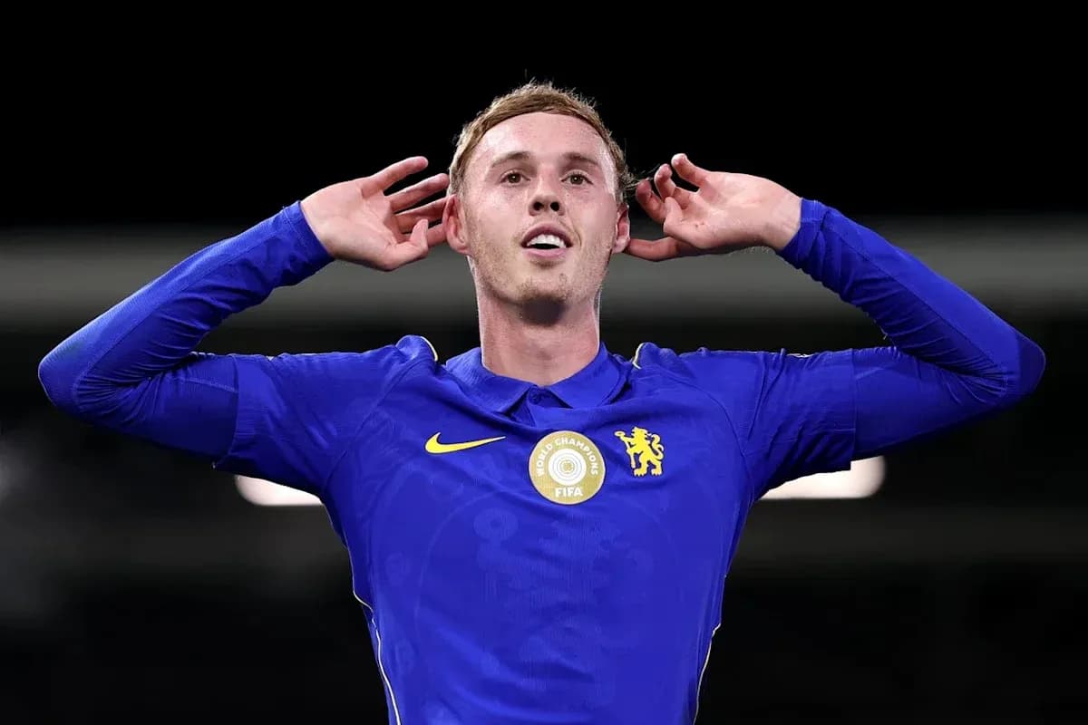 Player celebrating with hands behind ears in jersey