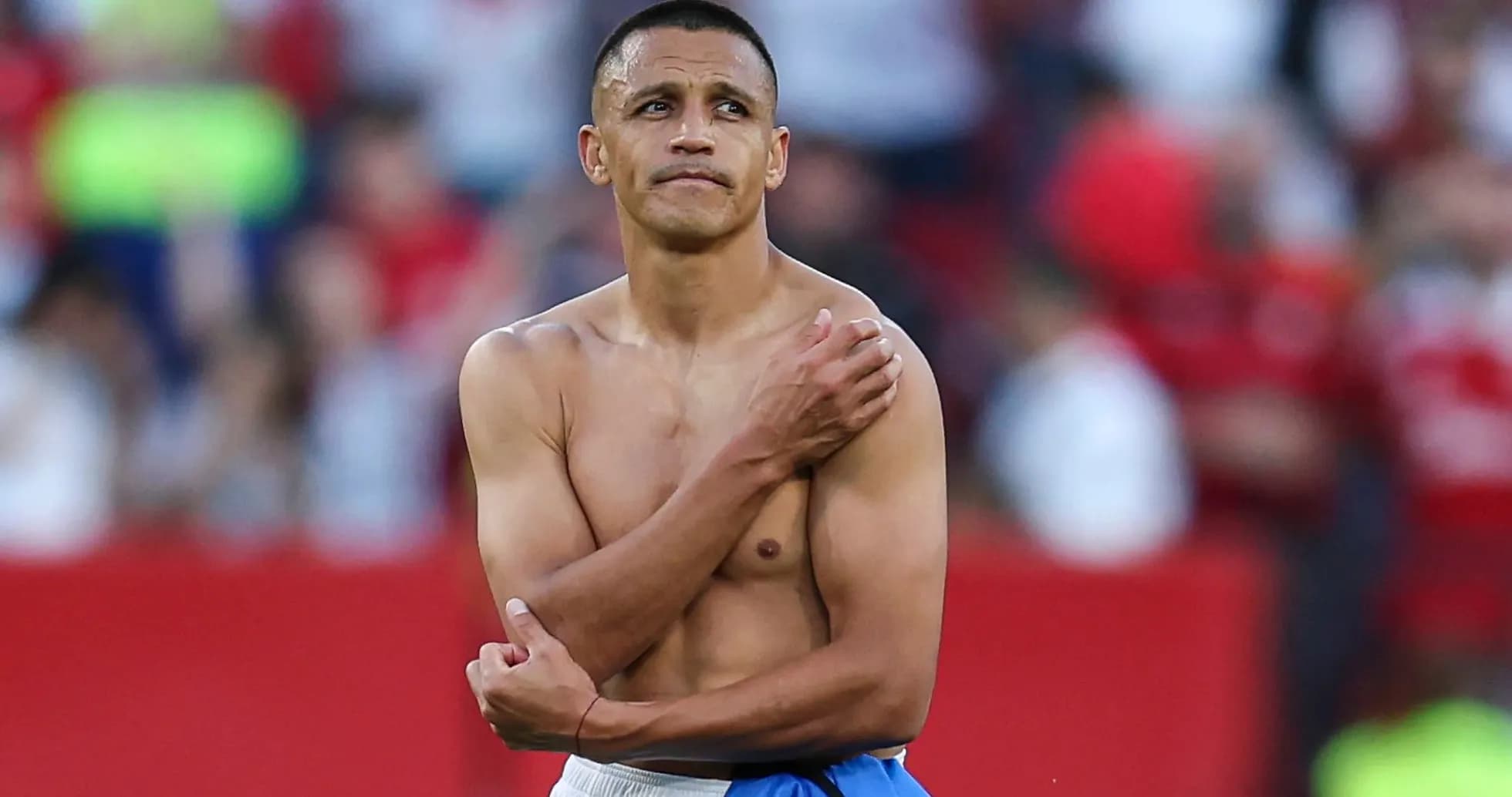 Player with no shirt standing on the field
