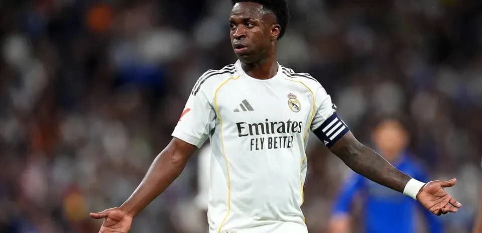 Player gesturing during a match wearing Real Madrid kit