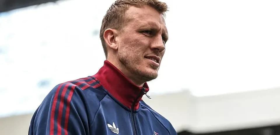 Player wearing training jacket on stadium pitch