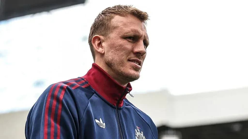 Player wearing training jacket on stadium pitch