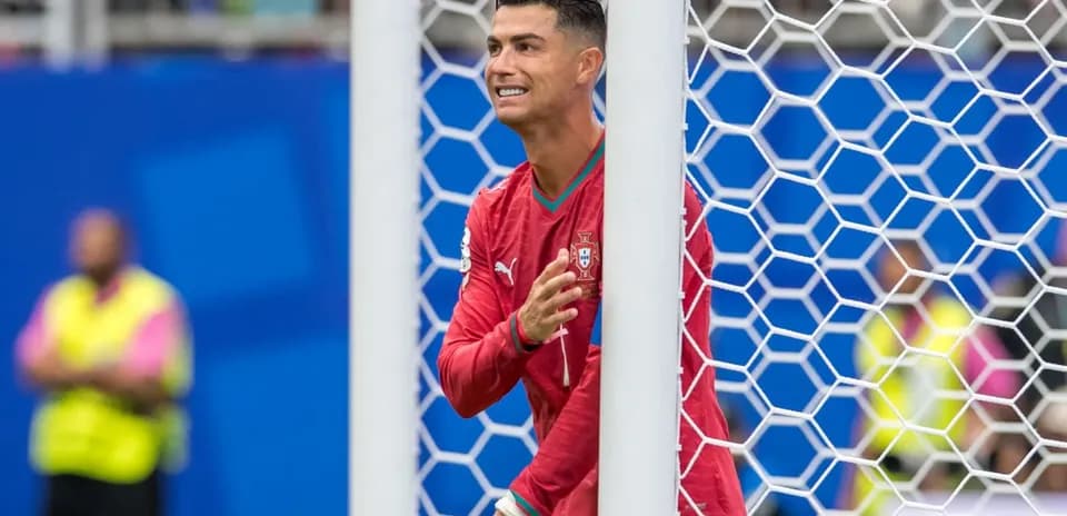 Cristiano Ronaldo gesturing from behind goal post
