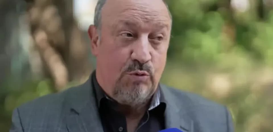 Man speaking during an outdoor interview with microphone