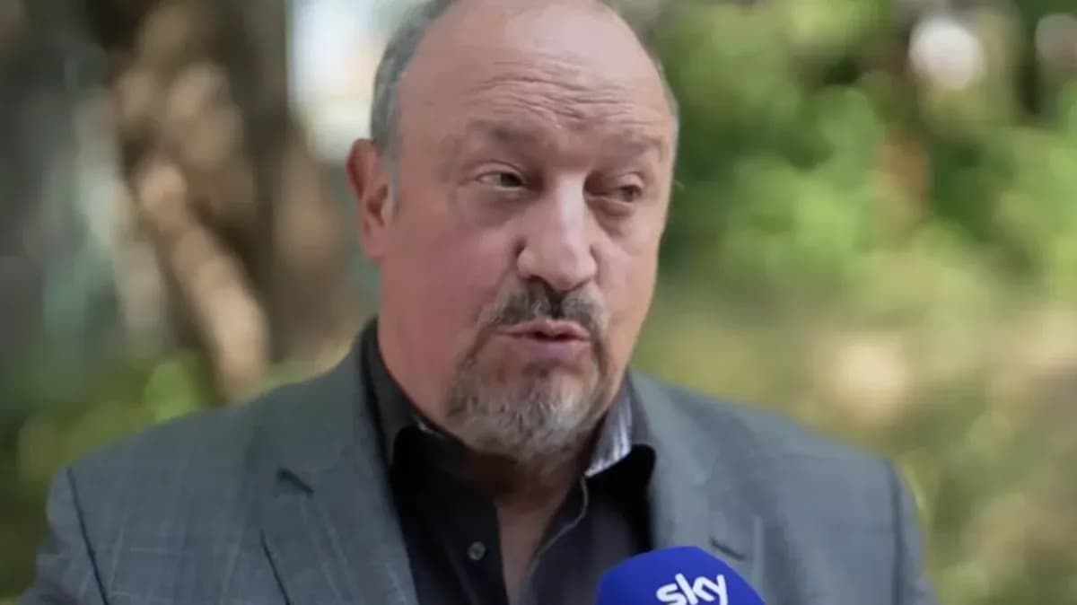 Man speaking during an outdoor interview with microphone