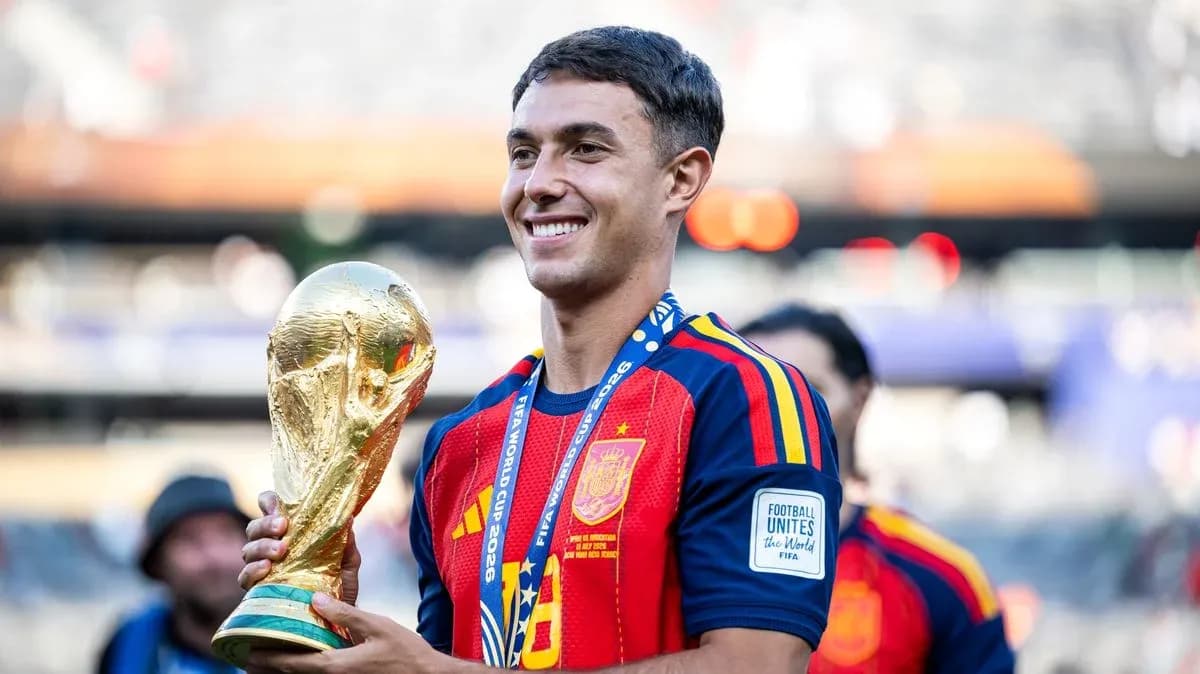 Player holding FIFA World Cup trophy in stadium