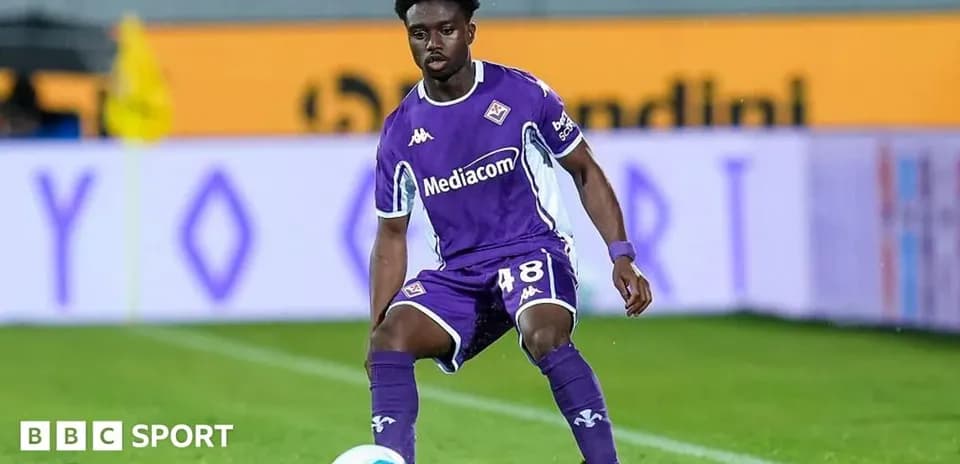 Player in purple kit preparing to receive ball