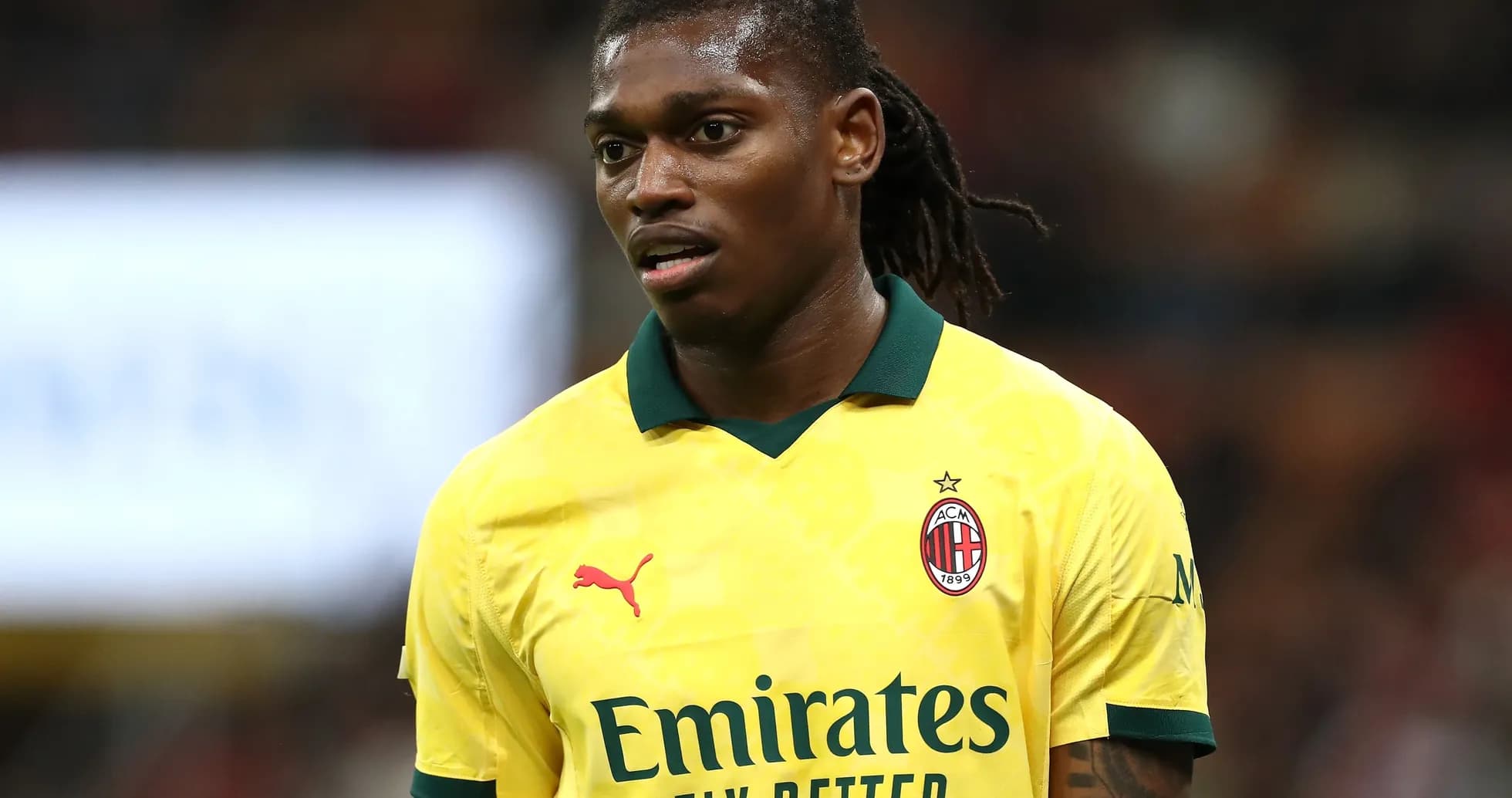 Player in yellow AC Milan jersey on the field
