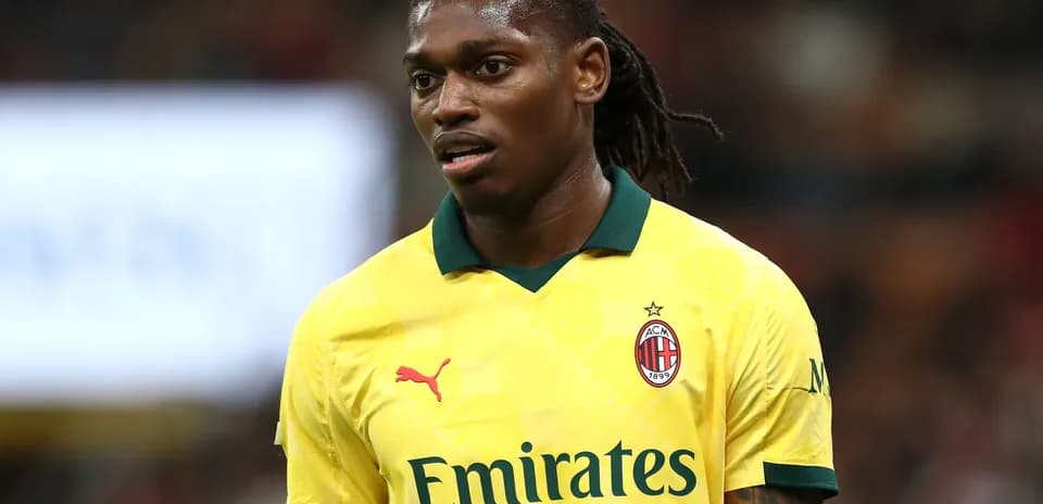 Player in yellow AC Milan jersey on the field