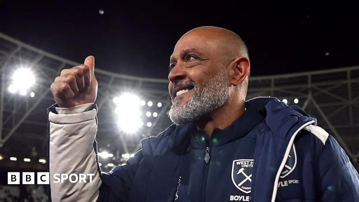 Manager celebrating with a thumbs up in stadium