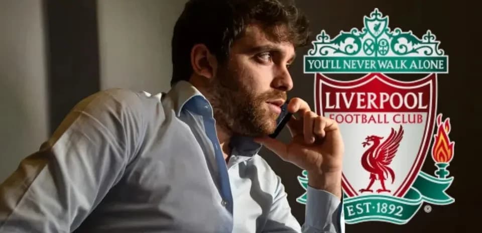 Man on phone beside Liverpool FC logo