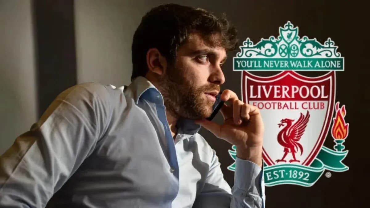 Man on phone beside Liverpool FC logo