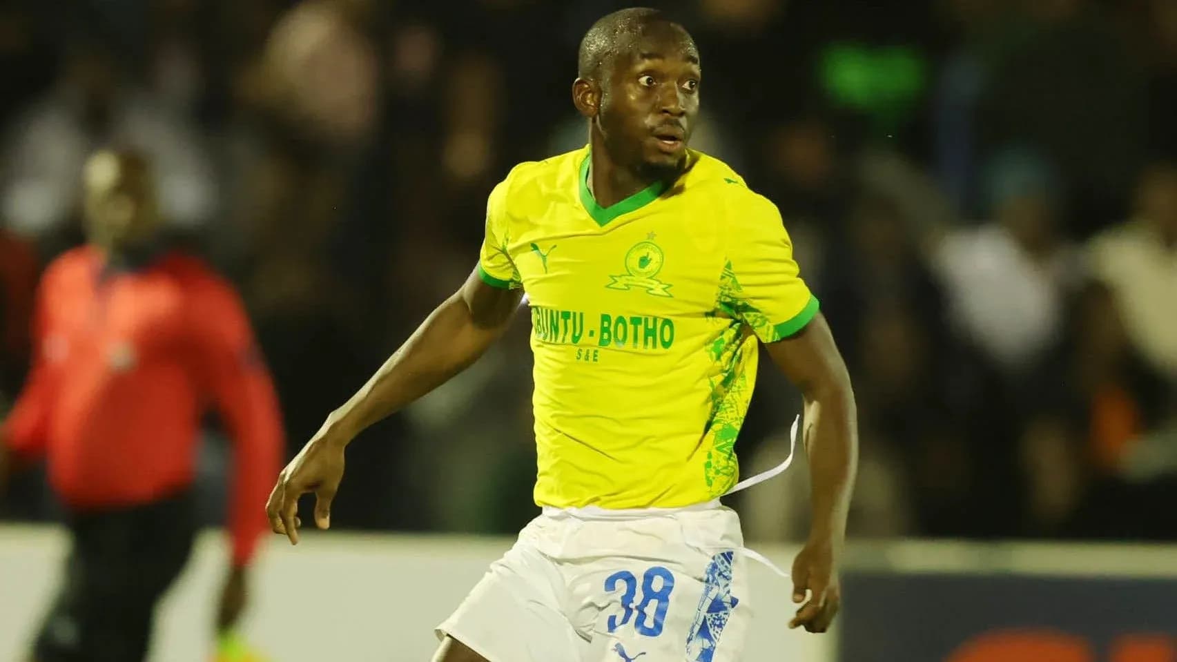Player in yellow jersey running on the field