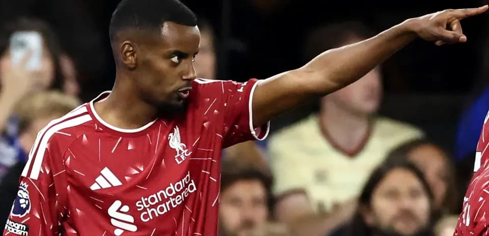 Player pointing during match wearing Liverpool kit