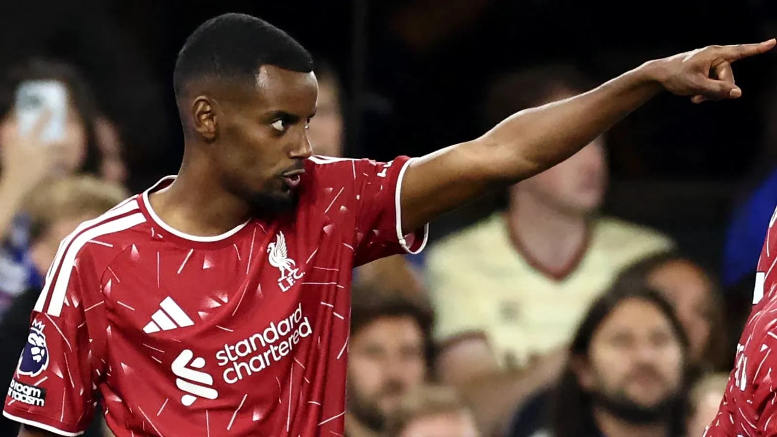 Player pointing during match wearing Liverpool kit