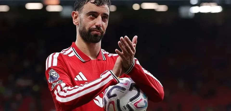Player applauding while holding a soccer ball