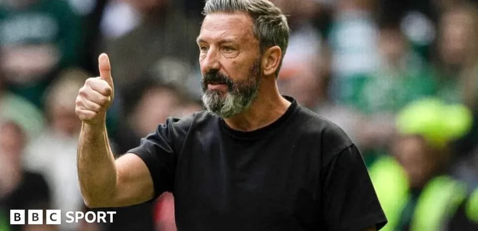 Manager giving a thumbs up during match
