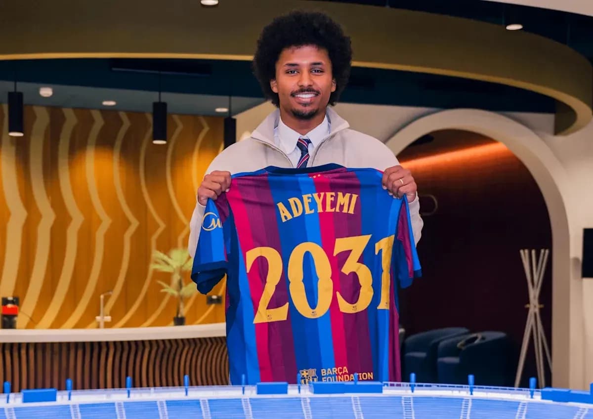 Player holding Barcelona jersey with 'Adeyemi 2031'
