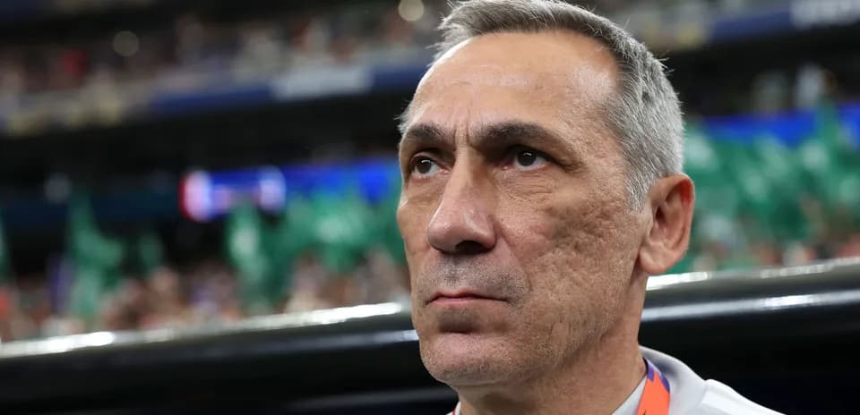 Coach focused during a match on the sidelines