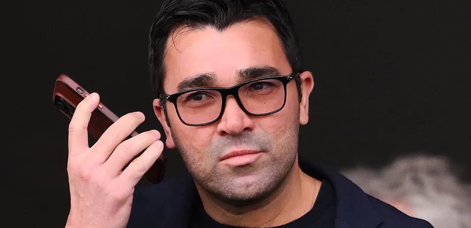 Person holding a phone, looking thoughtful
