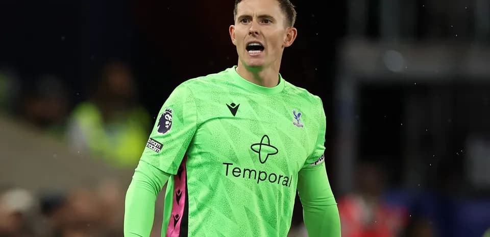 Goalkeeper in green kit shouting on the field