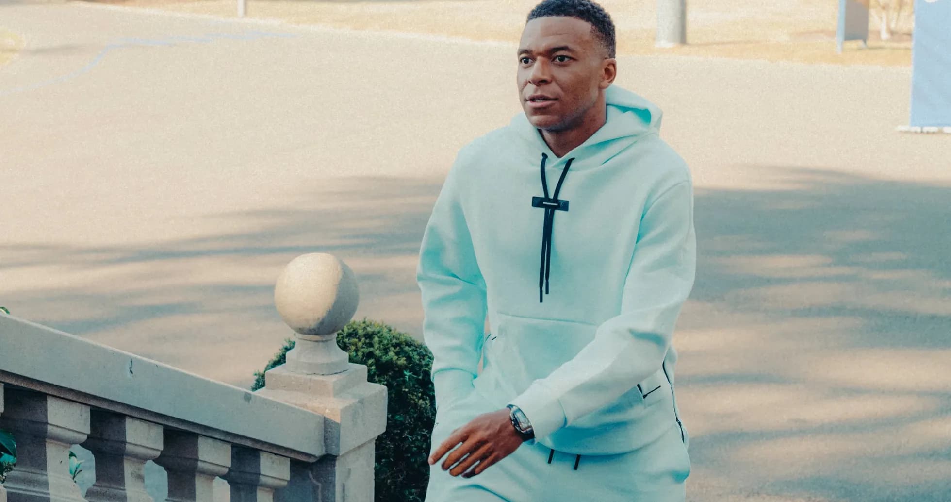 Player walking up stairs in light blue hoodie