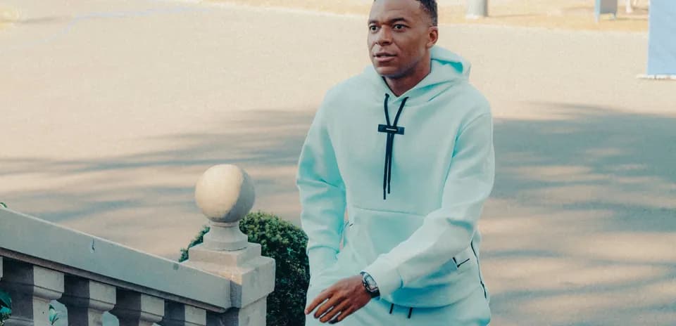 Player walking up stairs in light blue hoodie