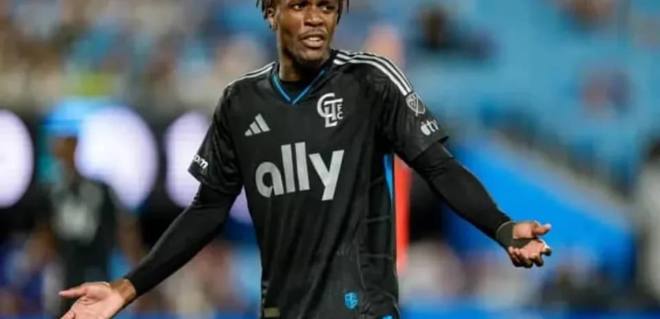 Player in black kit gesturing during match