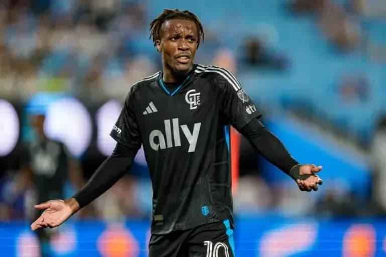 Player in black kit gesturing during match