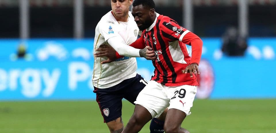 AC Milan player tackling Cagliari opponent