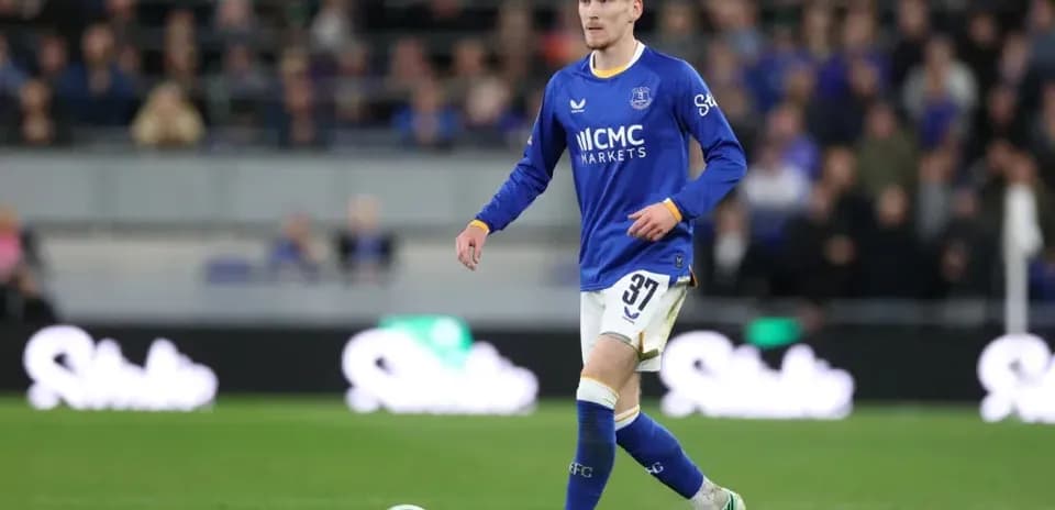 Player in blue jersey walking on the pitch